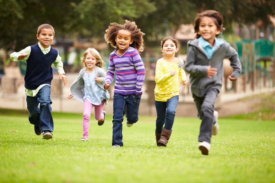Schoolagers running and playing outside